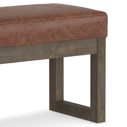 SIMPLIHOME Milltown 27" Wide Vegan Leather Ottoman in Saddle Brown | Distressed saddle brown, contemporary ottoman with a cushioned seat for bedroom seating; rectangle footstool or pouf. - color: Distressed Saddle Brown, style: Small Ottoman Bench