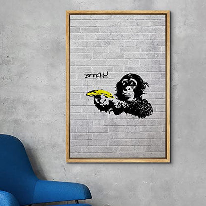 wall26 Framed Canvas Print Wall Art Banksy British Artist Spray Paint Monkey Banana Gun Graffiti & Street Art Urban Illustrations Modern Art Scenic for Living Room, Bedroom, Office - 16"x24" Natural - color: A12-2204-eva25, size: 24"L x 16"W