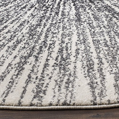 SAFAVIEH Evoke Collection Area Rug - 5'3" Round, Black & Ivory, Abstract Burst Design, Non-Shedding & Easy Care, Ideal for High Traffic Areas in Living Room, Bedroom (EVK228K)
